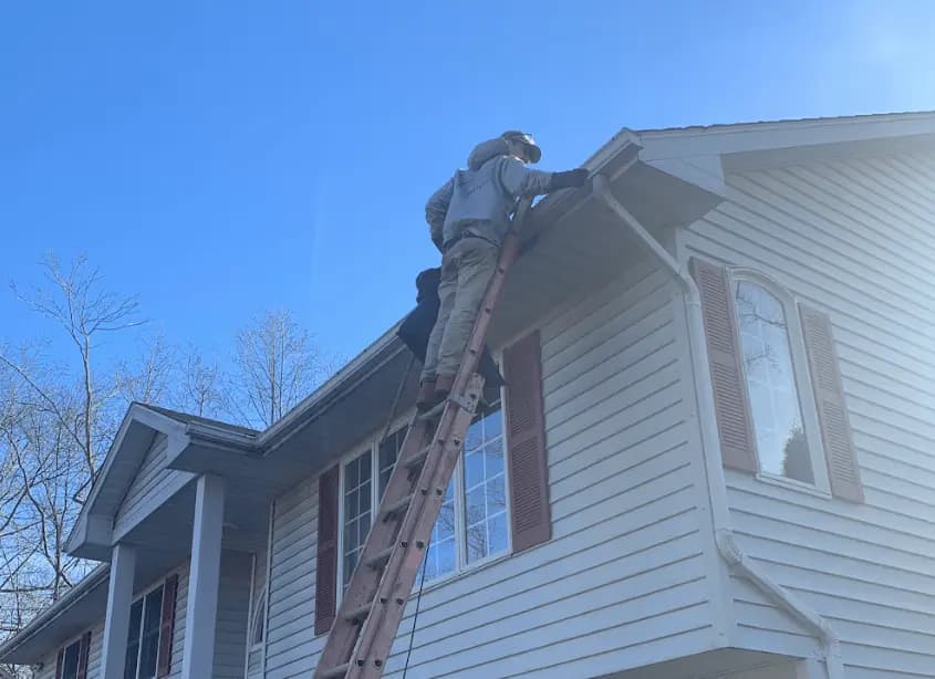 Gutter cleaning and maintenance being performed by Mayfield Heights Power Washing in Mayfield Heights